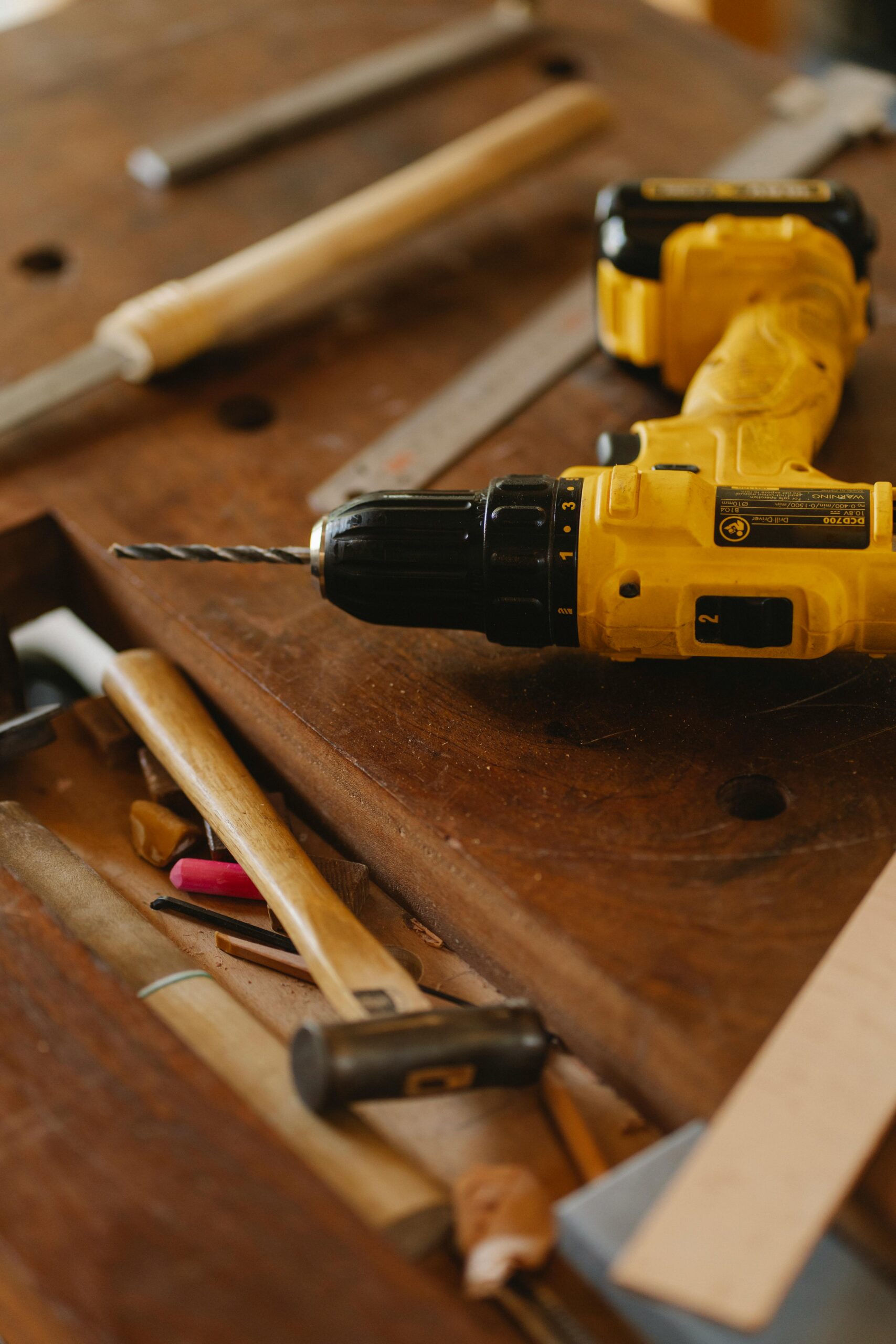 Modern convenient screwdriver drill among tools for carpentry